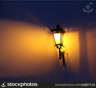 Soft focus. Decorative street lamps. Shadow and light on the wall