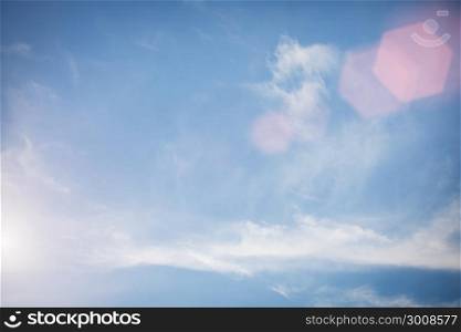 Soft focus of blue sky and cloud with flare. Vintage filtered nature background.