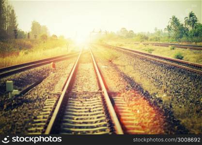 Soft focus of landscape of railroad tracks at train station in sunset. Vintage filtered.