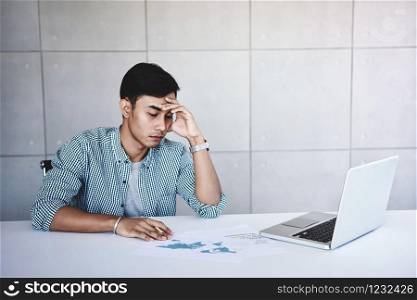 Soft Focus of Tired and Stress Young Businessman Sitting on Desk in Office with Computer Laptop. Exhausted Man Boring a Hard Work
