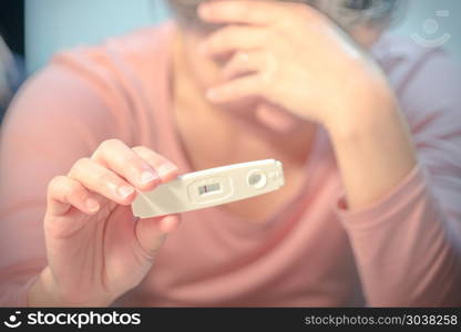 soft focus on the negative pregnancy test result hold on crying . soft focus on the negative pregnancy test result hold on crying women hand