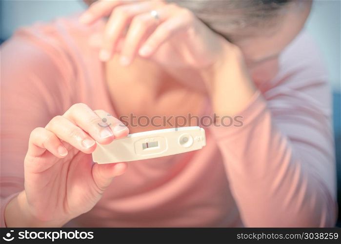 soft focus on the negative pregnancy test result hold on sad wom. soft focus on the negative pregnancy test result hold on sad women hand