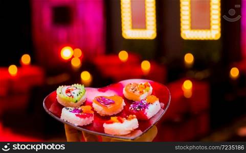 Soft Focus Valentines Day Heart Shaped Sushi Platter with Love lights in the background