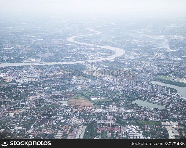 Soft focused of aerial view of Bangkok city and Chao Phraya river with morning fog overlay, capital of Thailand