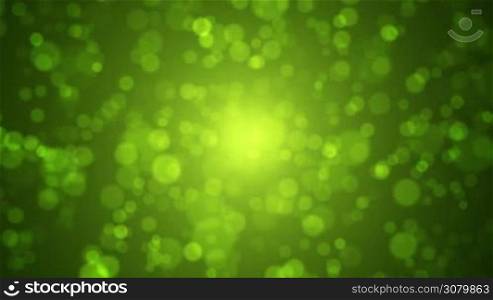 Soft green and gold bokeh motion background. Abstract spring concept.