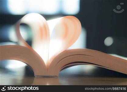 Soft heart paper book page. Vintage color of sunlight. Valentine, Love, Wedding.