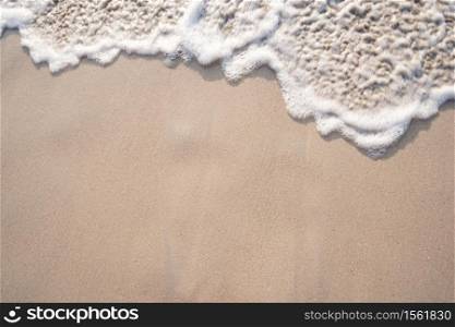 Soft ocean wave on tropical sandy beach in summer