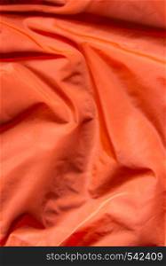 Soft Orange satin background texture close up view. Orange satin background texture