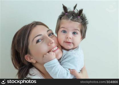 Soft view of Portrait of cute baby girl with expression on her face and laughing mom together.Isolated portrait.. Portrait view of cute baby girl and her mom