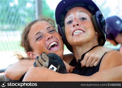 Softball Teammates Hugging Each Other And Laughing