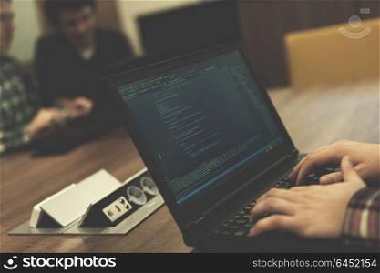software developer writing programming code on laptop computer