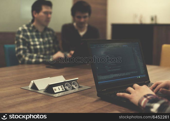 software developer writing programming code on laptop computer