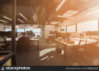 software developers working everyday job writing programming code at modern sunny bright open plan office