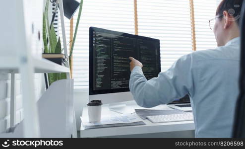 Software development concept, Male programmer checking data codes on document and computer screen.