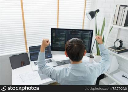 Software development concept, Male programmer excited and raise arms after successful programming.