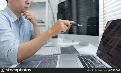 Software development concept, Male programmer pointing on laptop screen to checking data codes.