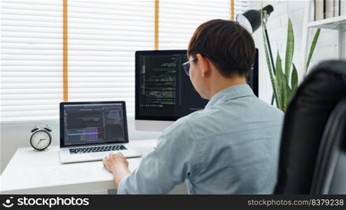Software development concept, Male programmer typing data code on laptop to develop app and website.