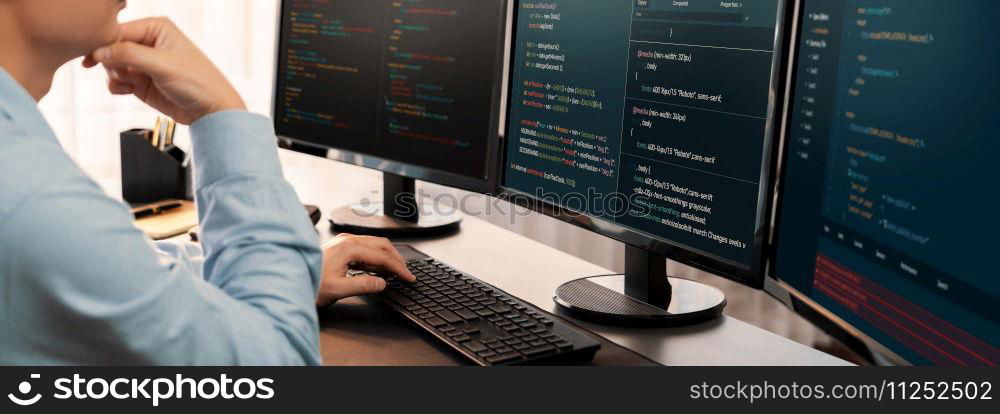 Software engineer working on application development on his computer display code and script on monitor at tech company office workplace. Application developer solving and writing code. Trailblazing. Application developer solving and writing code. Trailblazing