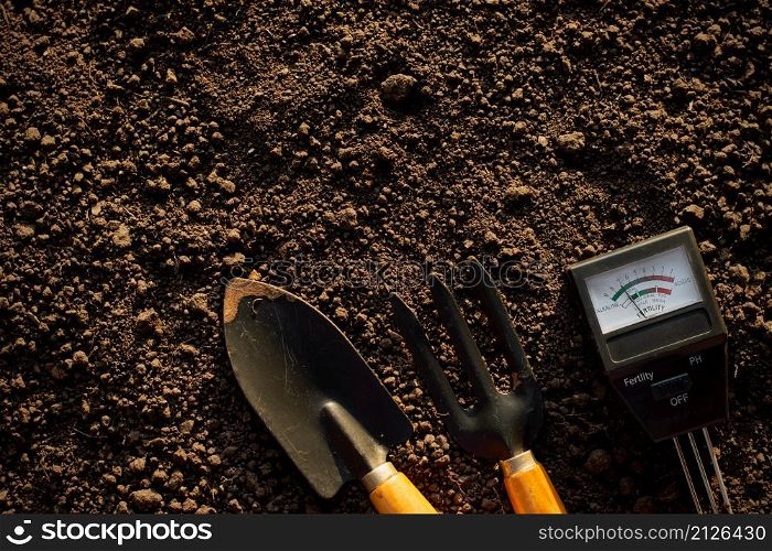 Soil meters and farming equipment are placed on the soil for cultivation.