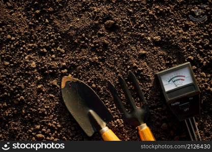 Soil meters and farming equipment are placed on the soil for cultivation.
