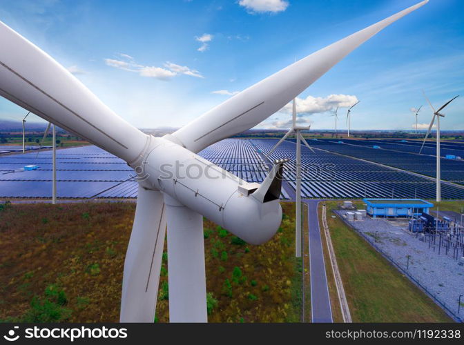 Solar energy panel photovoltaic cell and wind turbine farm power generator in nature landscape for production of renewable green energy is friendly industry. Clean sustainable development concept.