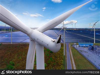 Solar energy panel photovoltaic cell and wind turbine farm power generator in nature landscape for production of renewable green energy is friendly industry. Clean sustainable development concept.