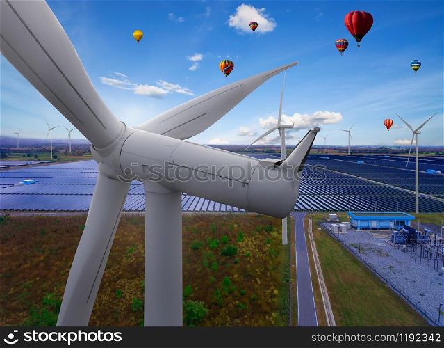 Solar energy panel photovoltaic cell and wind turbine farm power generator in nature landscape for production of renewable green energy is friendly industry. Clean sustainable development concept.