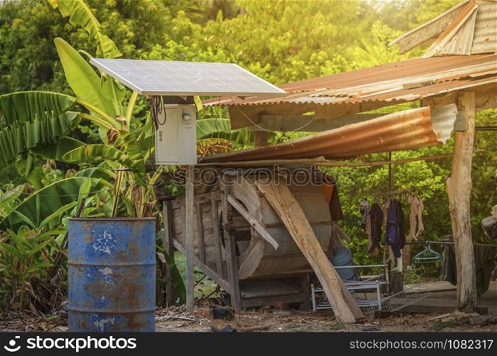 Solar panel in a rural houses area and old oil barrels are ready to recycle Industrial,Agro-industry of household Rural style in Thailand, Alternative energy concept