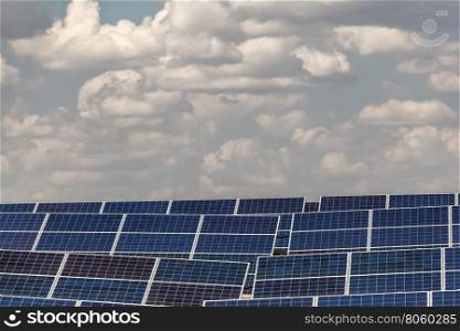 solar panels against the sky. elements of solar power plants against the sky with clouds