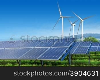 solar panels and wind turbines under blue sky on summer landscape. solar panels and wind turbines under blue sky