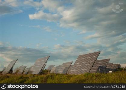 Solar panels in the landscape with a cloudy sky of background