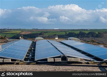 Solar panels on the roof of a building generating clean renewable electrical energy