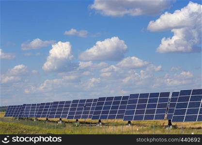solar panels standing at the field at the bright sunny day