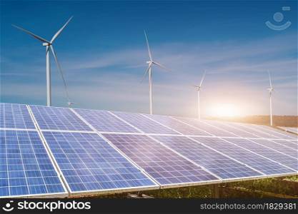 solar panels with wind turbines against blue sky background. Photovoltaic, alternative electricity source. sustainable resources concept.