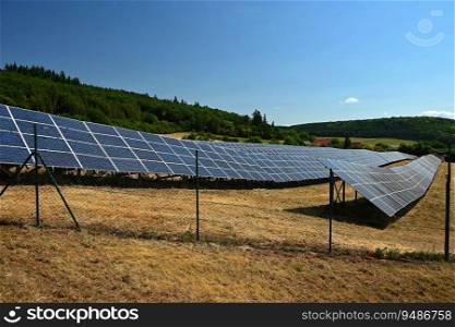 Solar power plant - concept for electricity and ecological industry. High energy prices. Beautiful landscape and sunny day with blue sky. Photovoltaic power plant.