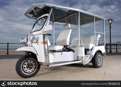 Solar powered tuc tuc on the beach on an afternoon