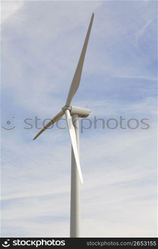 Solar powered wind turbine against blue sky