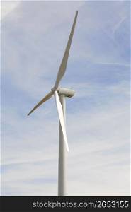 Solar powered wind turbine against blue sky