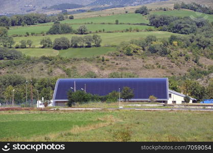 solar roof of a large curved surface on a municipal building of a small village in the Pyrenees