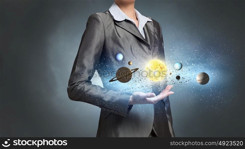 Solar sytem and planets of universe. Close up of businesswoman holding planets of sun system in hand
