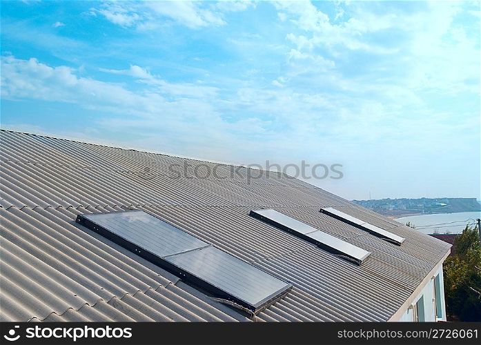 Solar water heating system on the house roof.