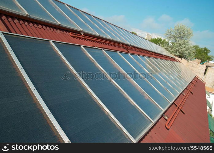 Solar water heating system on the red roof. Gelio panels.