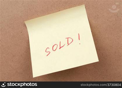 Sold word written on a sticky note