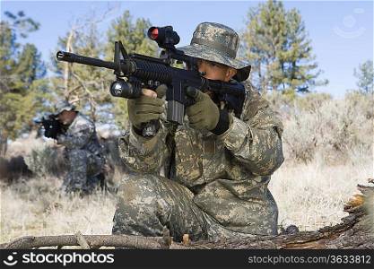Soldier aiming machine gun