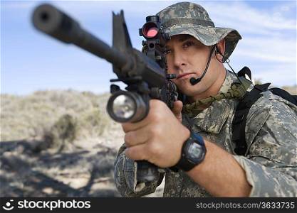 Soldier aiming machine gun, close-up