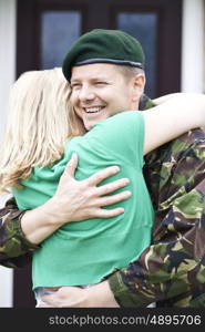 Soldier Visiting Home On Leave Hugging Wife