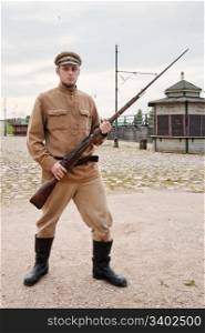 Soldier with a gun in uniform of World War I. Costume accord the times of World War I. Photo made at cinema city Cinevilla in Latvia.