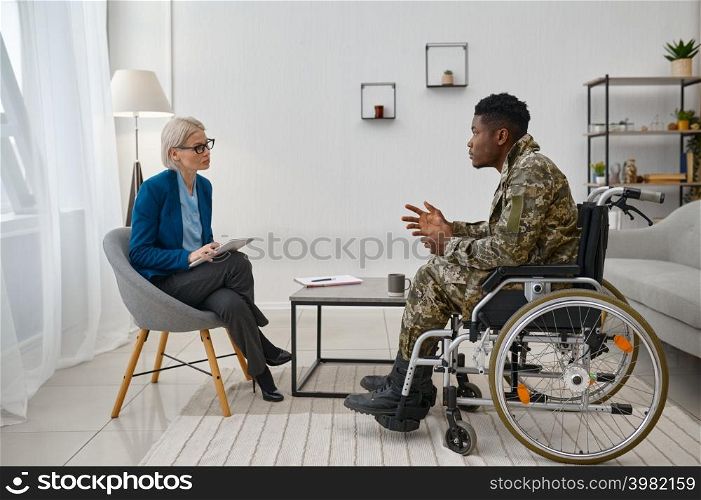 Soldier with disability in wheelchair visiting psychologist. Professional psychological consultation. Soldier with disability at professional psychological consultation