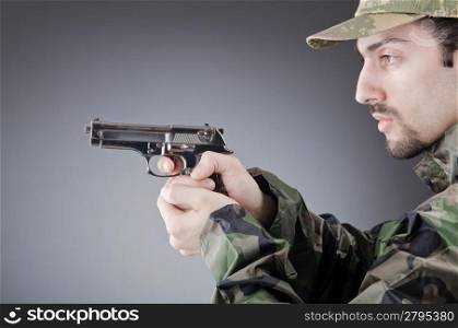 Soldier with gun in studio shooting