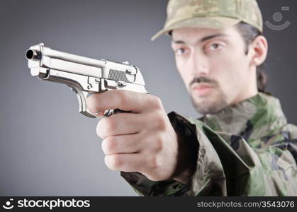 Soldier with gun in studio shooting